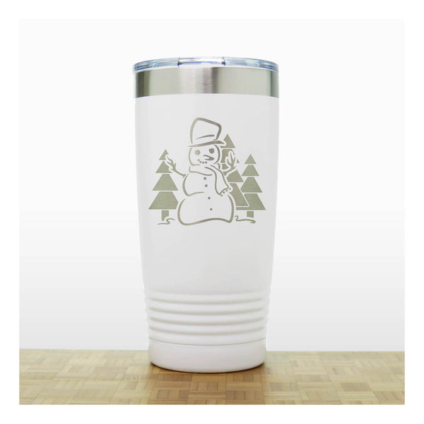 White 20 oz Insulated Tumbler with the design of a snowman standing in front of Christmas trees - Copyright Hues in Glass