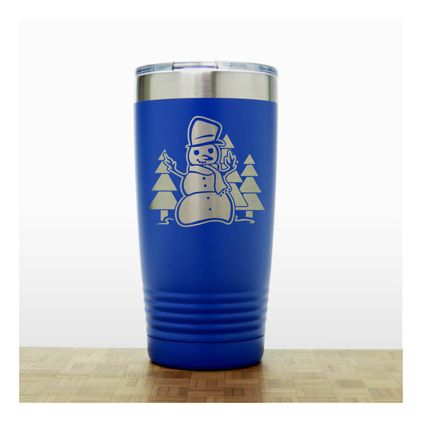 Blue 20 oz Insulated Tumbler with the design of a snowman standing in front of Christmas trees - Copyright Hues in Glass