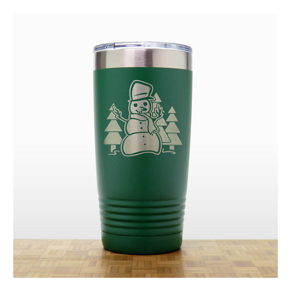 Green 20 oz Insulated Tumbler with the design of a snowman standing in front of Christmas trees - Copyright Hues in Glass