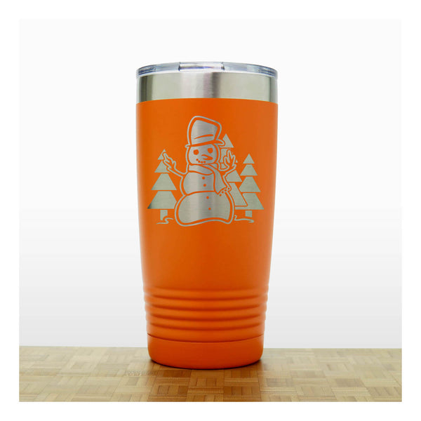 Orange 20 oz Insulated Tumbler with the design of a snowman standing in front of Christmas trees - Copyright Hues in Glass