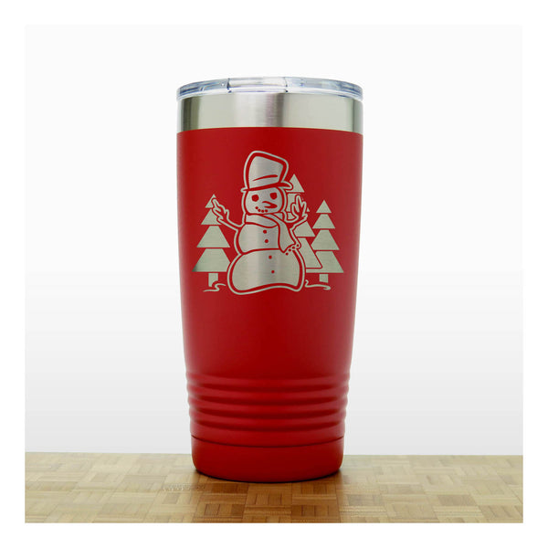 Red 20 oz Insulated Tumbler with the design of a snowman standing in front of Christmas trees - Copyright Hues in Glass