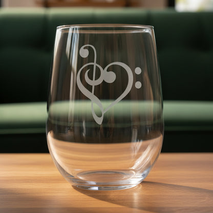 treble clef, bass clef Heart stemless wine glass with a green couch behind it