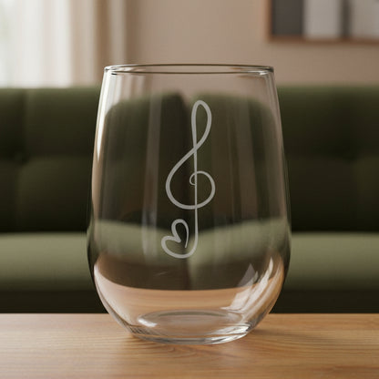Treble Clef stemless wine glass with a green couch behind it