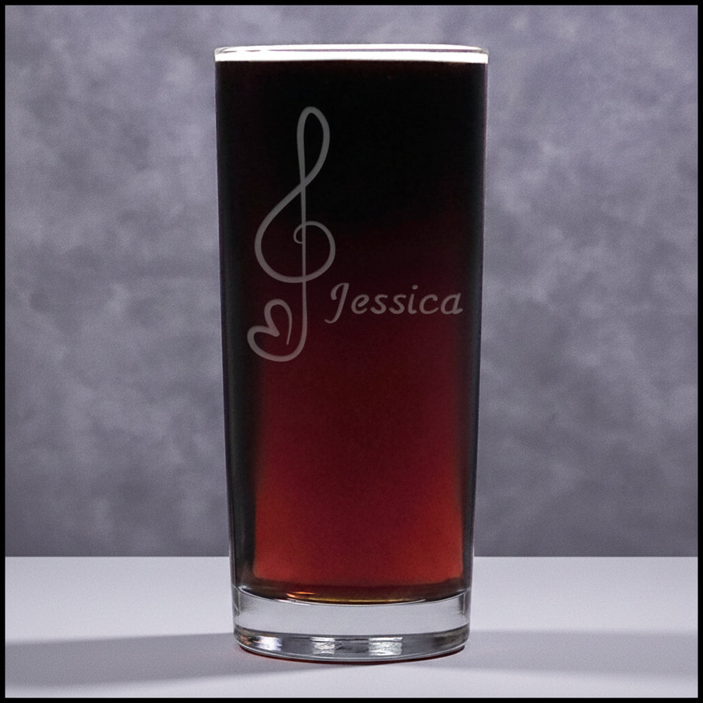 Cooler glass mug with a treble clef with heart "tail" engraving filled on a grey surface 
