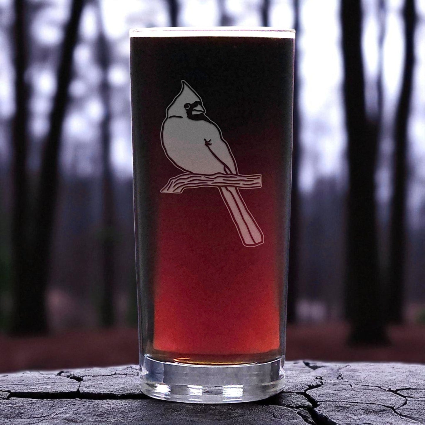 Glass with a bird design on a forest background