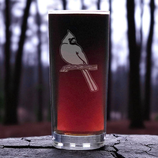 Glass with a bird design on a forest background
