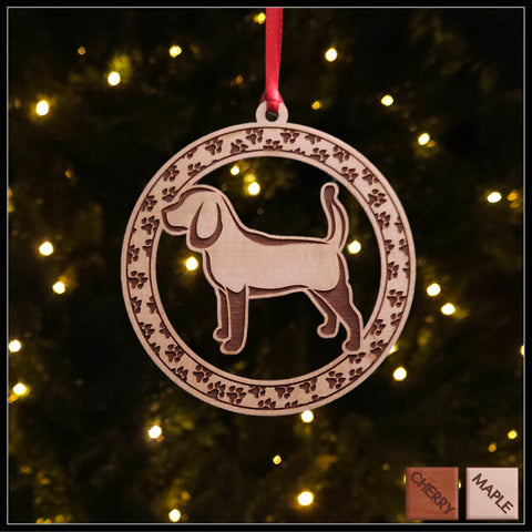 A round maple wood veneer ornament with a border of small paw prints. The center of the ornament is a beagle dog