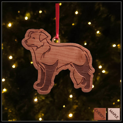 A Border Collie dog cherry wood veneer ornament, with the dog in profile. 