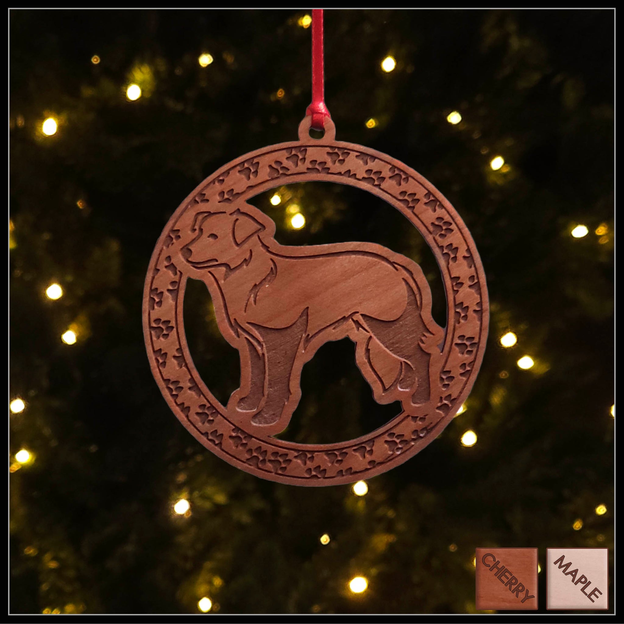A round cherry wood veneer ornament with a border of small paw prints. The center of the ornament is a border collie dog