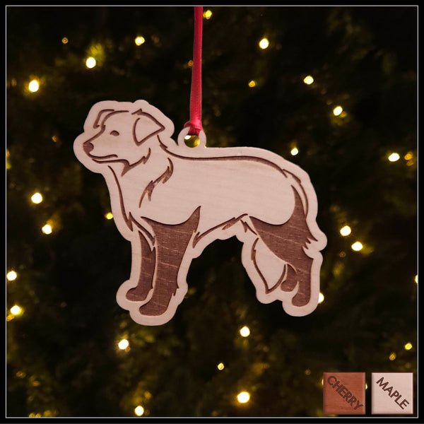 A Border Collie dog maple wood veneer ornament, with the dog in profile. 