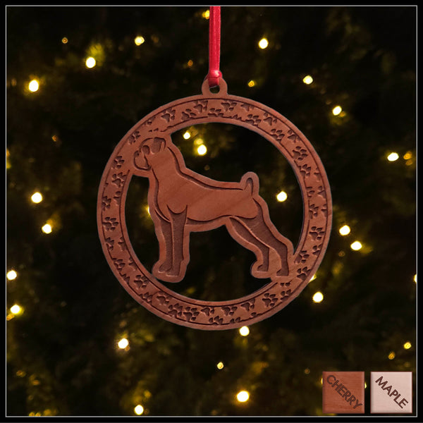 A round cherry wood veneer ornament with a border of small paw prints. The center of the ornament is a boxer dog