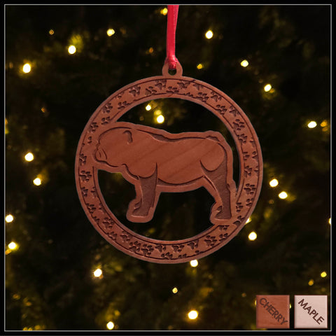 A round cherry wood veneer ornament with a border of small paw prints. The center of the ornament is a bulldog