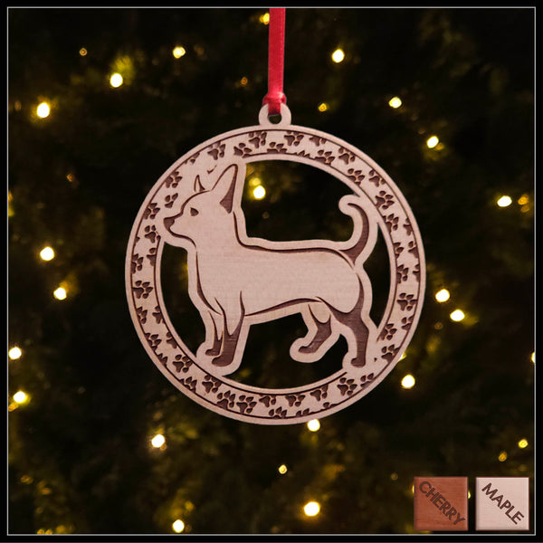 A round maple wood veneer ornament with a border of small paw prints. The center of the ornament is a chihuahua dog