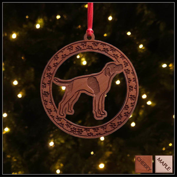 A round cherry wood veneer ornament with a border of small paw prints. The center of the ornament is a English Pointerdog.