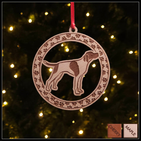 A round Maple wood veneer ornament with a border of small paw prints. The center of the ornament is a English Pointerdog.