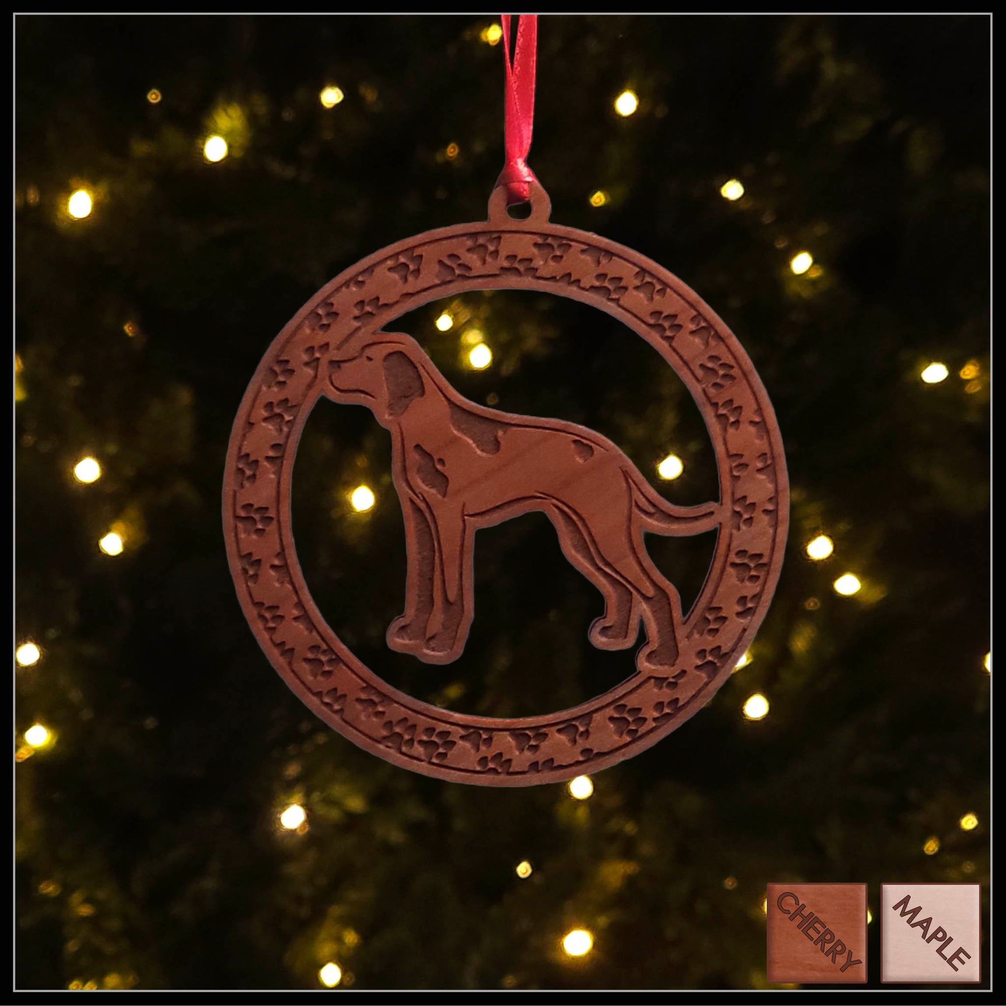 A round cherry wood veneer ornament with a border of small paw prints. The center of the ornament is a English Pointer dog.