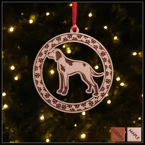 A round Maple wood veneer ornament with a border of small paw prints. The center of the ornament is a English Pointer dog.