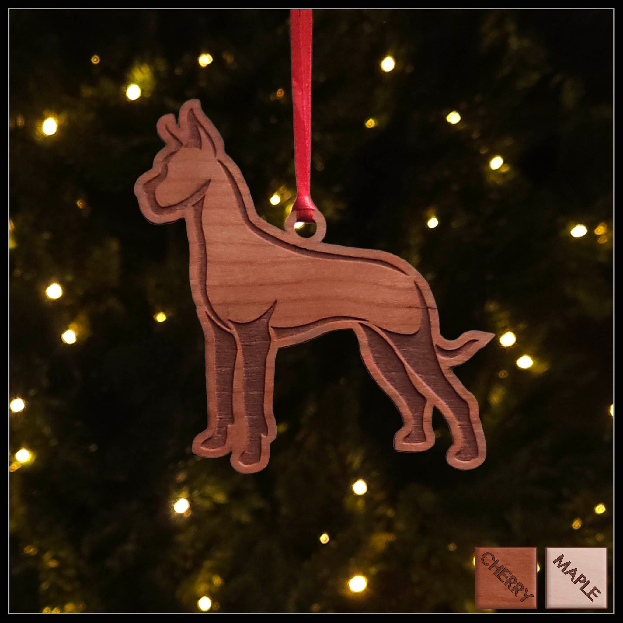 A Great Dane cherry wood veneer ornament, with the dog in profile. 
