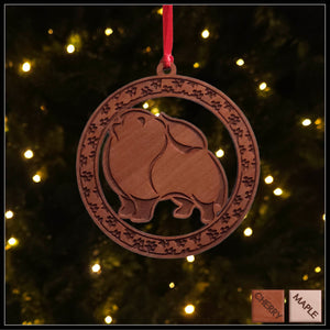 A round cherry wood veneer ornament with a border of small paw prints. The center of the ornament is a Pomeranian dog.