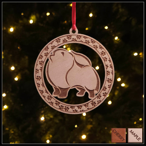A round Maple wood veneer ornament with a border of small paw prints. The center of the ornament is a Pomeranian dog.