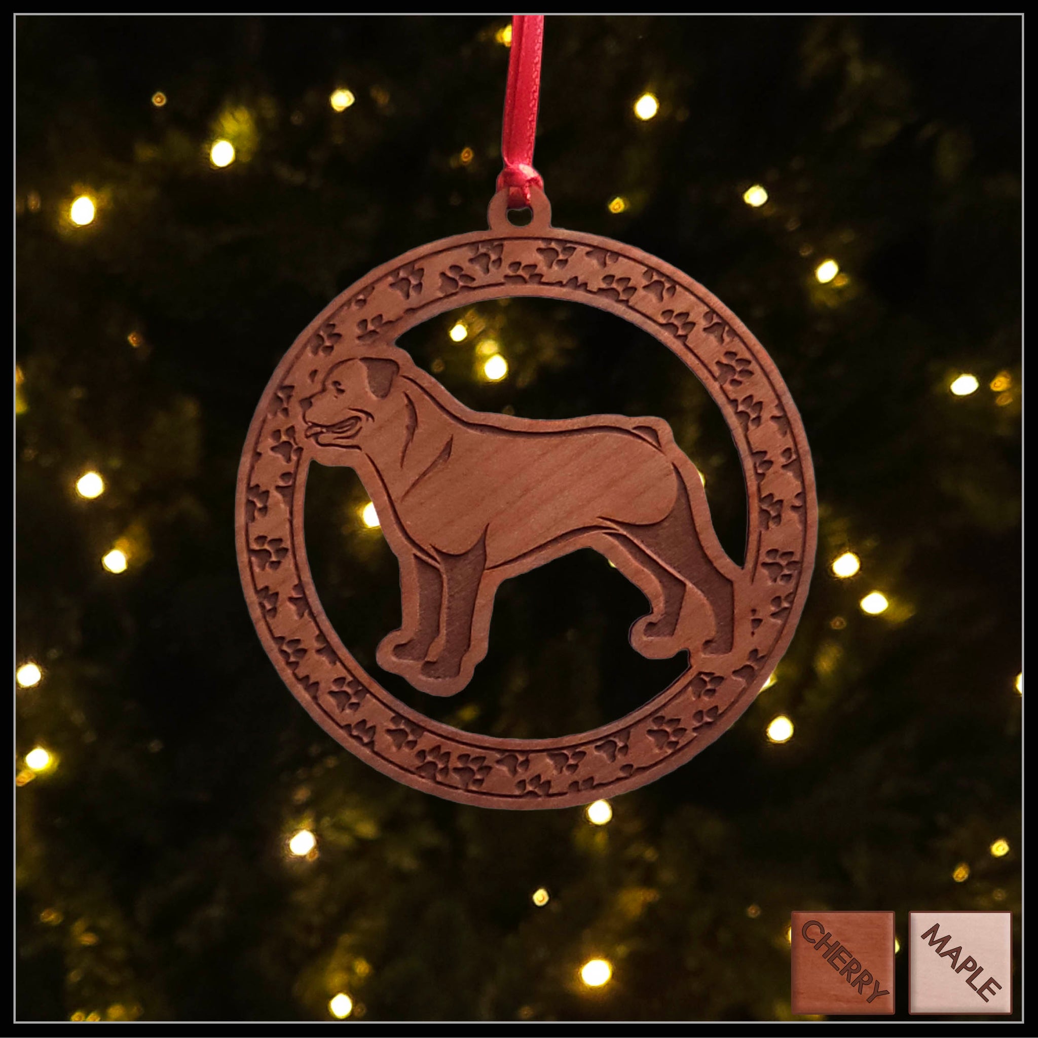 A round cherry wood veneer ornament with a border of small paw prints. The center of the ornament is a Rottweiler dog.