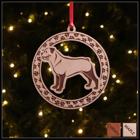 A round Maple wood veneer ornament with a border of small paw prints. The center of the ornament is a Rottweiler dog.