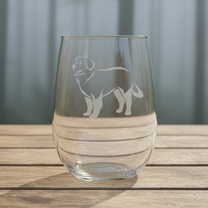 Clear stemless wine  glass with a bernese mountain  dog etching on a wooden surface