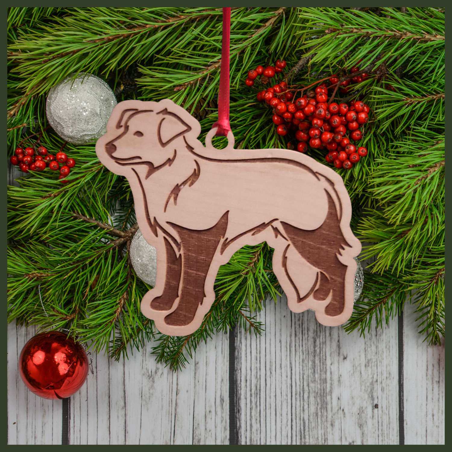 A Border Collie dog maple wood veneer ornament, with the dog in profile. 