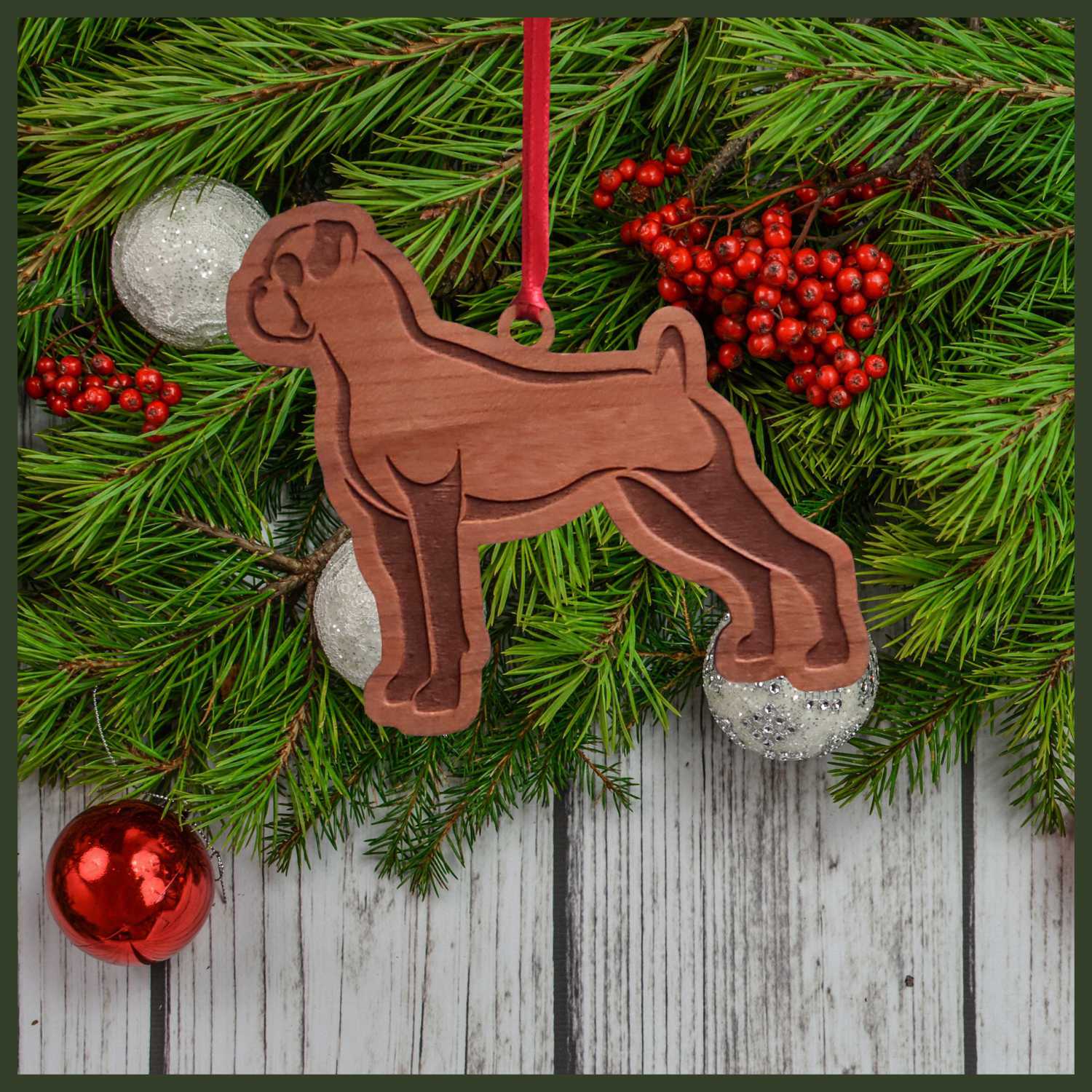 A Boxer dog cherry wood veneer ornament, with the dog in profile. 