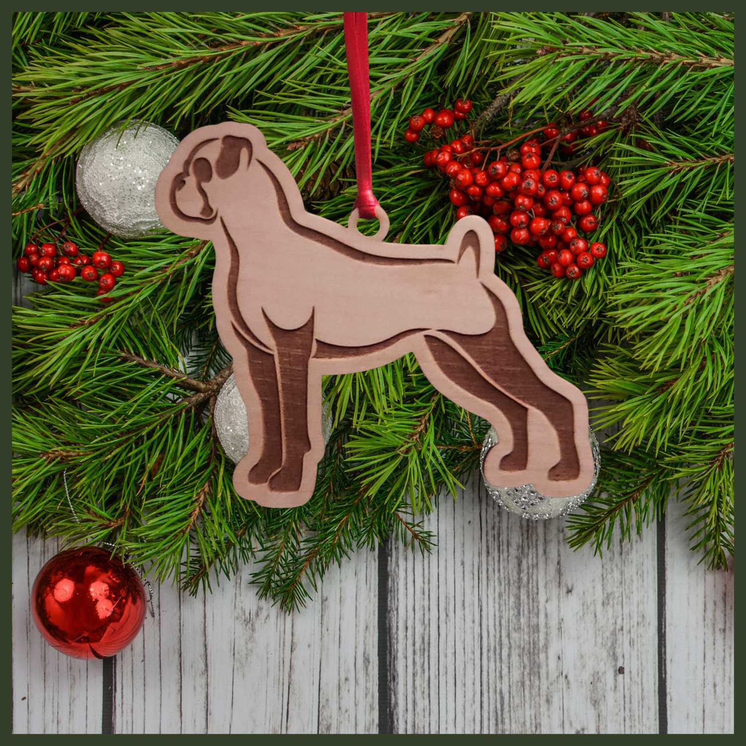 A Boxer dog maple wood veneer ornament, with the dog in profile. 