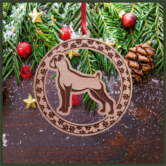 A round maple wood veneer ornament with a border of small paw prints. The center of the ornament is a boxer dog