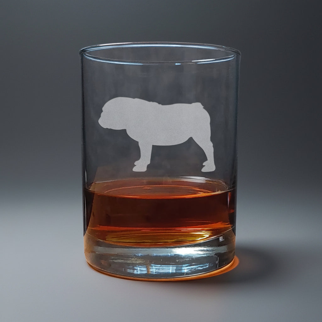 Clear glass with bulldog etching filled with amber liquid in a seamless background
