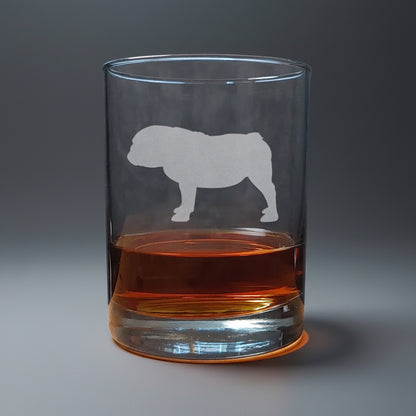 Clear glass with bulldog etching filled with amber liquid in a seamless background

