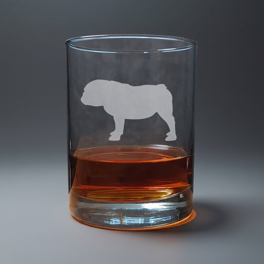 Clear glass with bulldog etching filled with amber liquid in a seamless background
