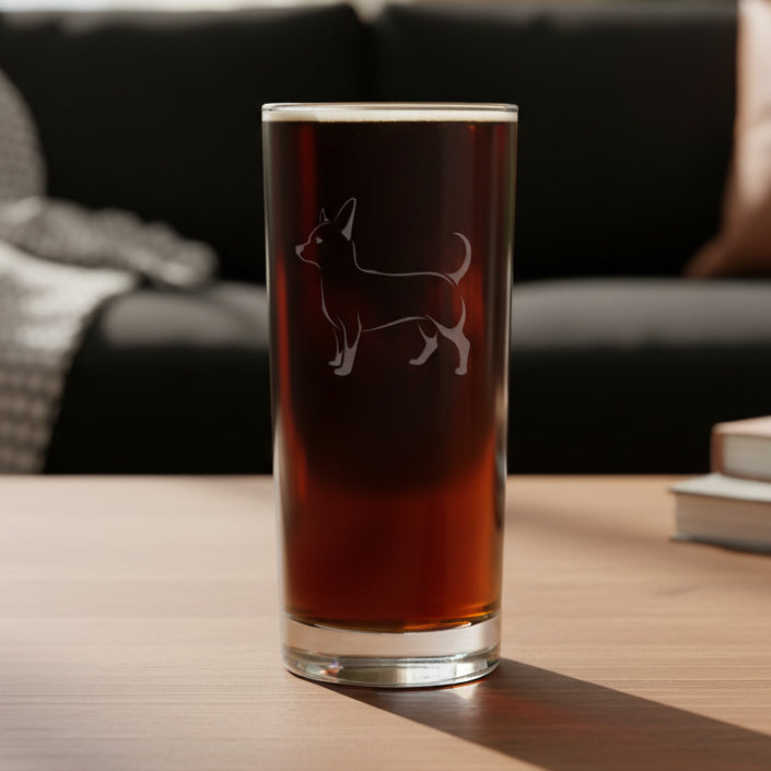 Cooler glass with a etched chihuahua dog with a black couch  in the background 