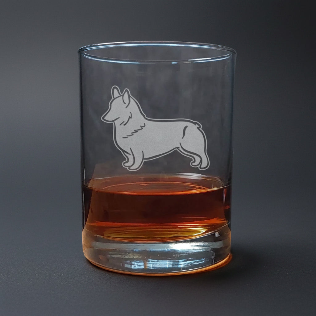 Clear glass with a corgi dog etching on a wooden surface and dark background