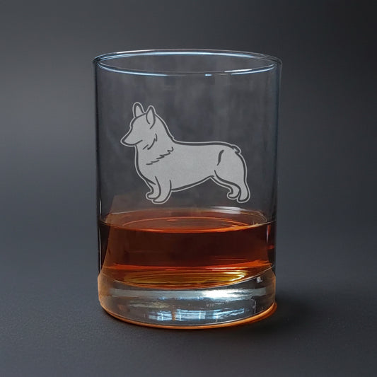 Clear glass with a corgi dog etching on a wooden surface and dark background