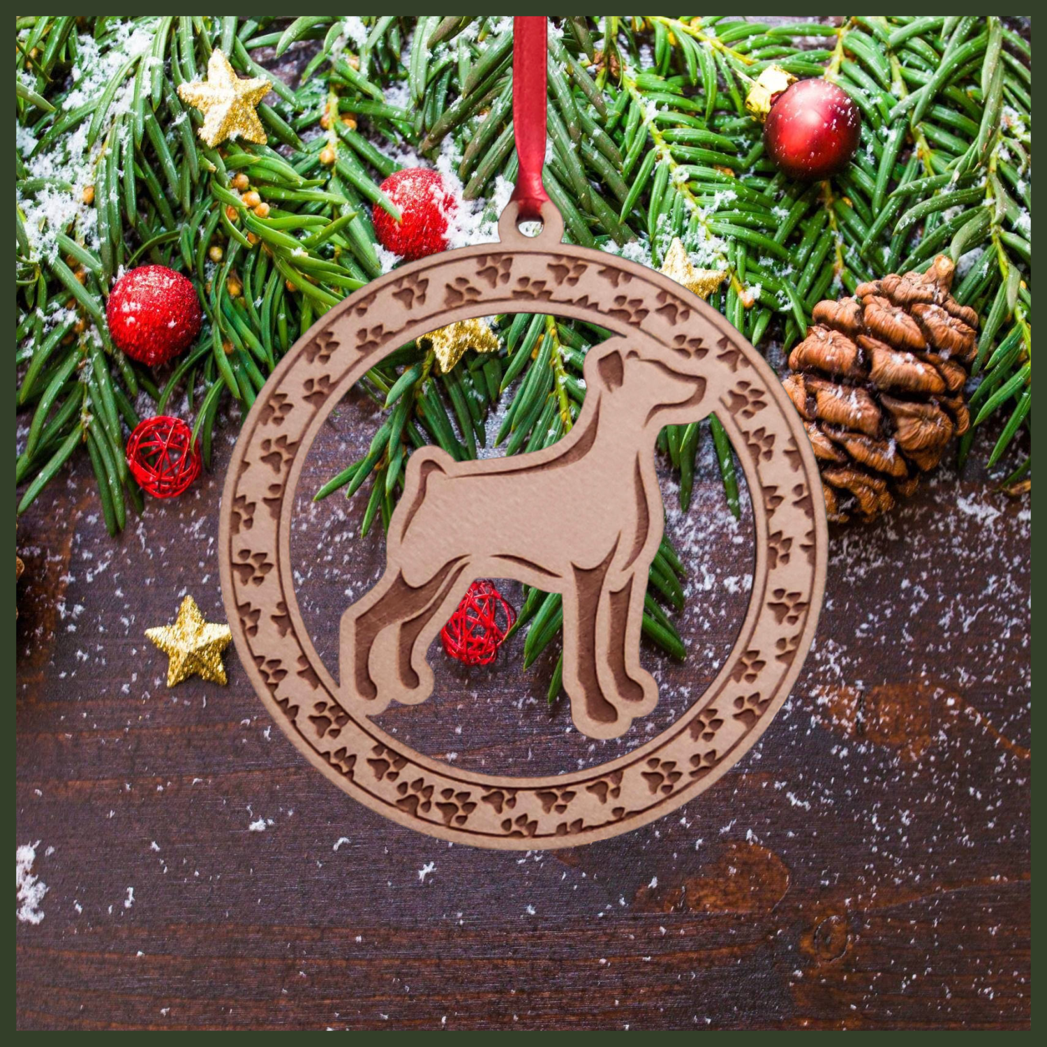 A round maple wood veneer ornament with a border of small paw prints. The center of the ornament is a Doberman dog.