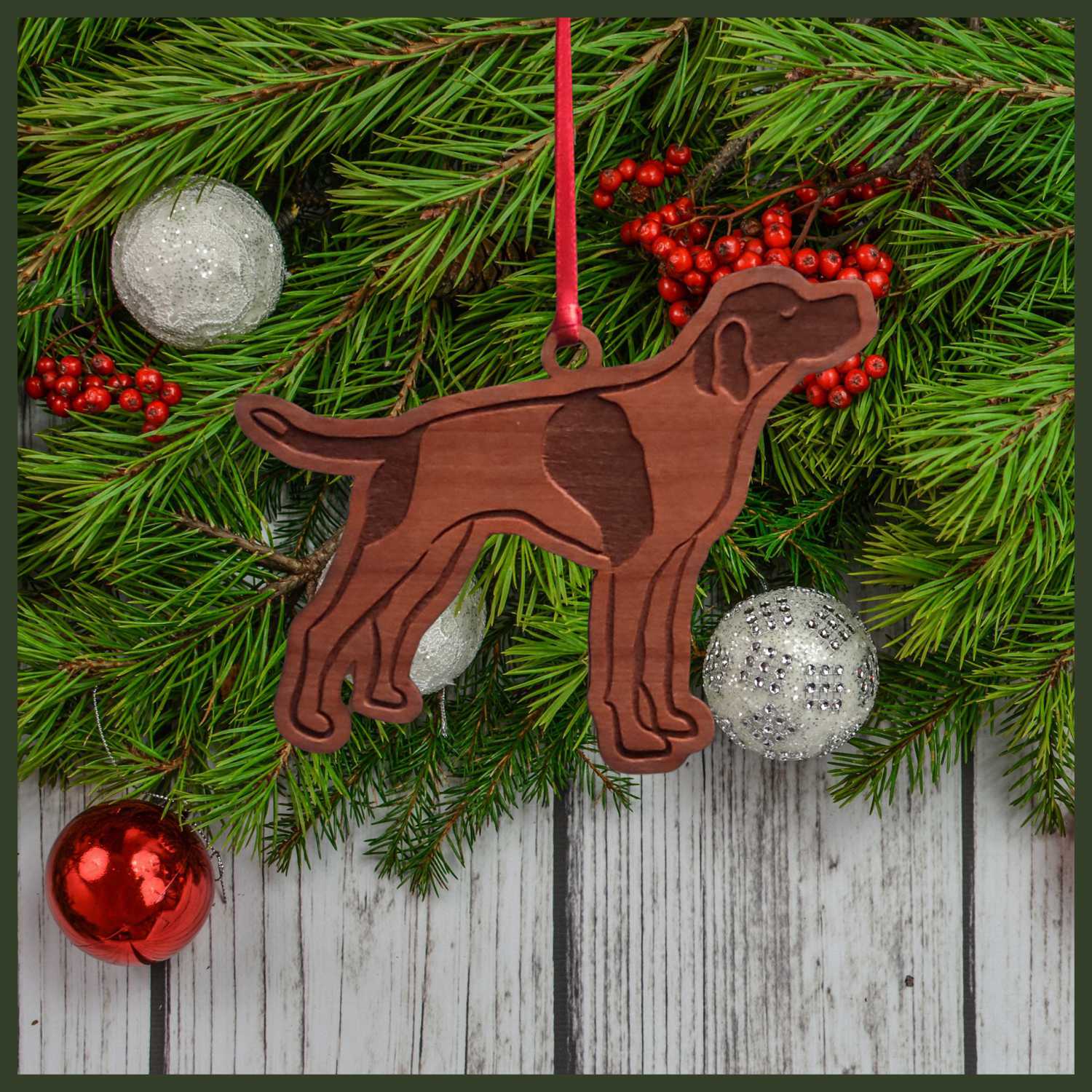 A English Pointer cherry wood veneer ornament, with the dog in profile. 