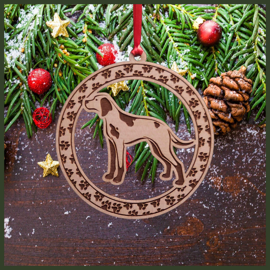 A round Maple wood veneer ornament with a border of small paw prints. The center of the ornament is a English Pointer dog.
