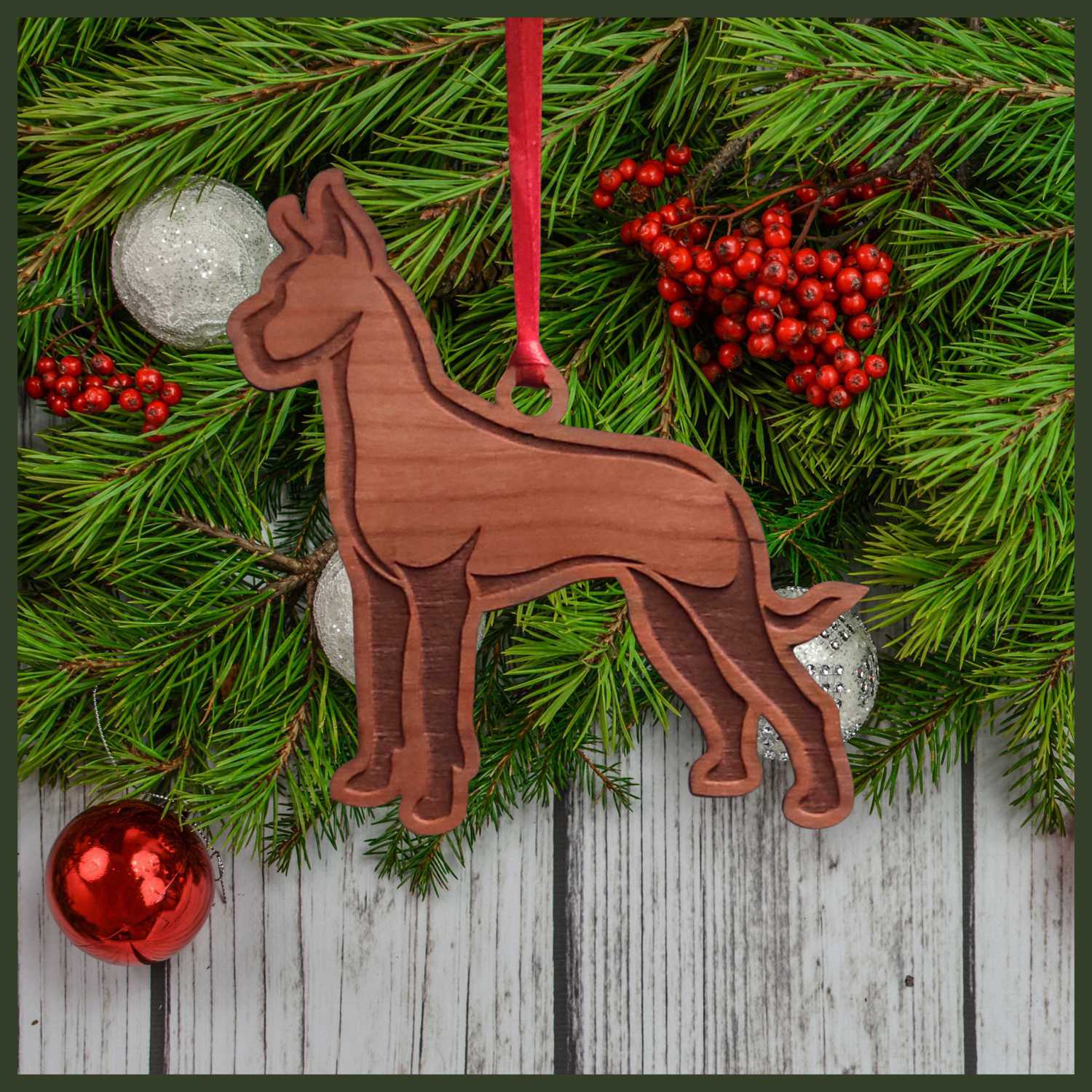 A Great Dane cherry wood veneer ornament, with the dog in profile. 