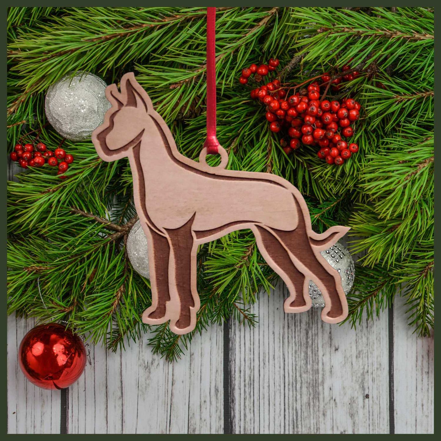 A Great Dane maple wood veneer ornament, with the dog in profile. 