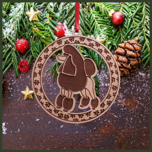  A round Maple wood veneer ornament with a border of small paw prints. The center of the ornament is a Poodle dog.