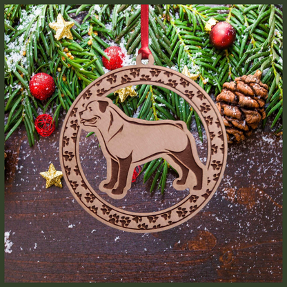 A round Maple wood veneer ornament with a border of small paw prints. The center of the ornament is a Rottweiler dog.