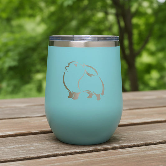 Turquoise insulated wine tumbler with a Pomeranian Dog on a wooden surface
