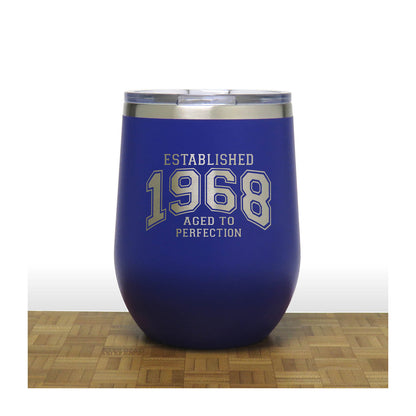 Blue wine tumbler with 'Established 1968 Aged to Perfection' text on a wooden surface.