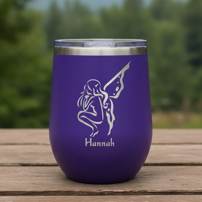 Purple tumbler with a white silhouette and 'Hannah' text on a wooden surface.