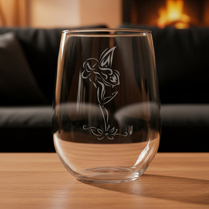 Clear glass with fairy etching on a wooden surface