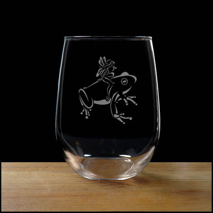 17oz Stemless Wine Glass with an etched image of a frog, on a wood surface and a black background