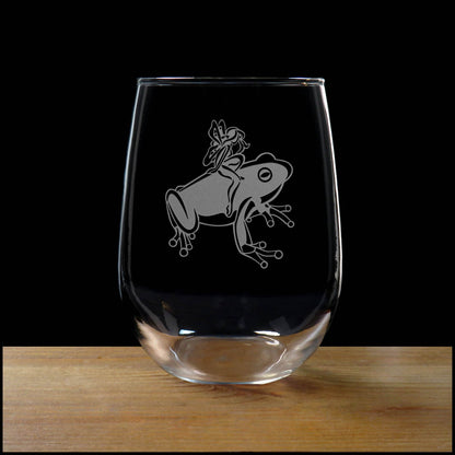 17oz Stemless Wine Glass with an etched image of a frog, on a wood surface and a black background